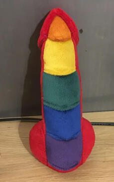 Red knotted penis with scales down the front: orange, yellow, green, blue, and purple.