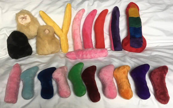 3 sheaths in beige and black, and a variety of penises in assorted colours - most smooth and simple, a few with features such as nubs