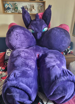 Large purple stuffed doll with large breasts, large ears, and detailed vulva